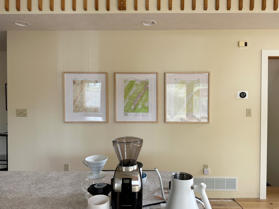 A long open wall across from a cluttered kitchen island.