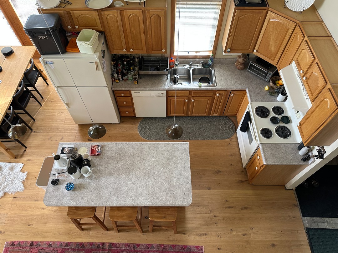 A cluttered and dated kitchen shown from overhead.